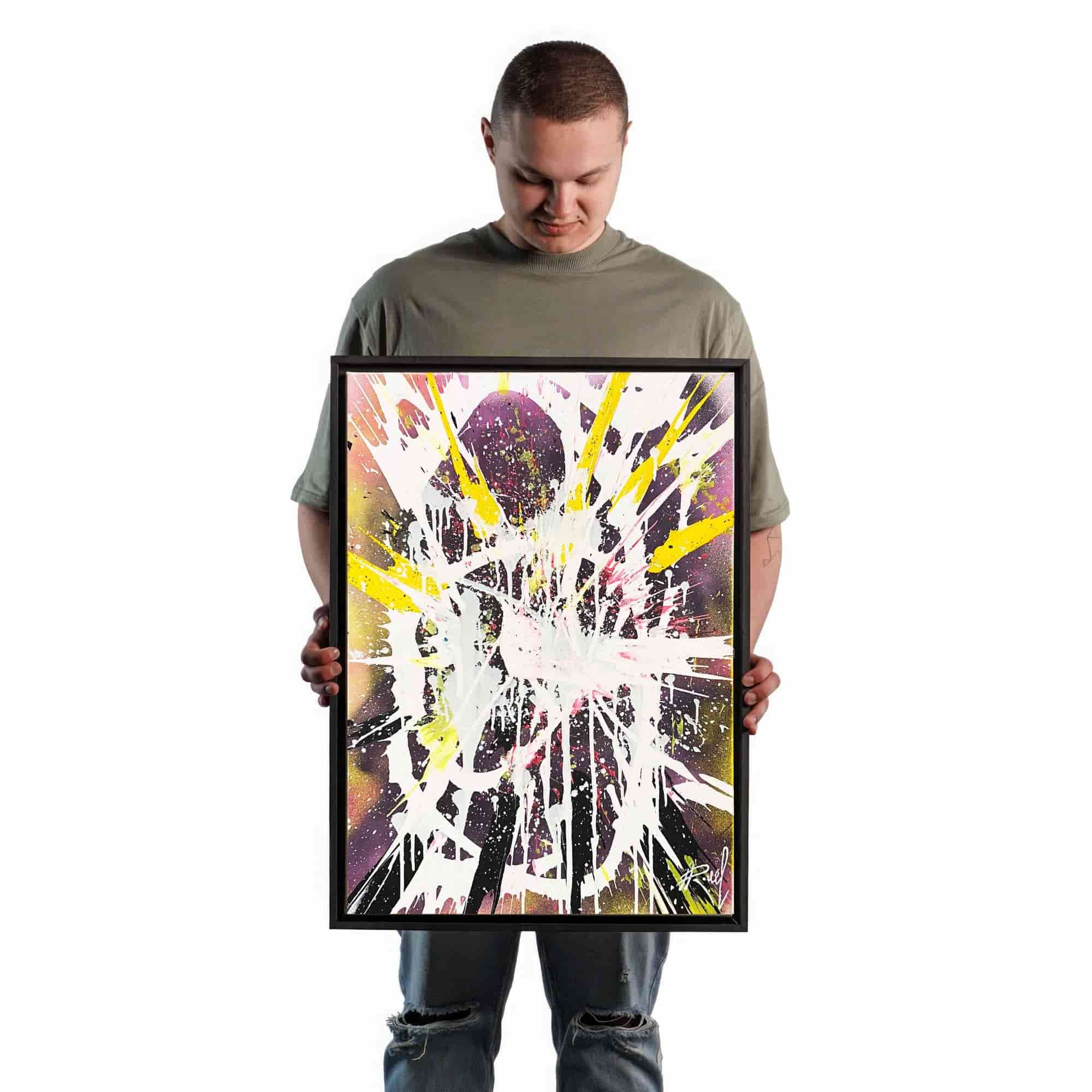 Artist presents the grandeur and scale of spin art technique, holding the Italian canvas masterpiece as a testament to acrylic paints' beauty.