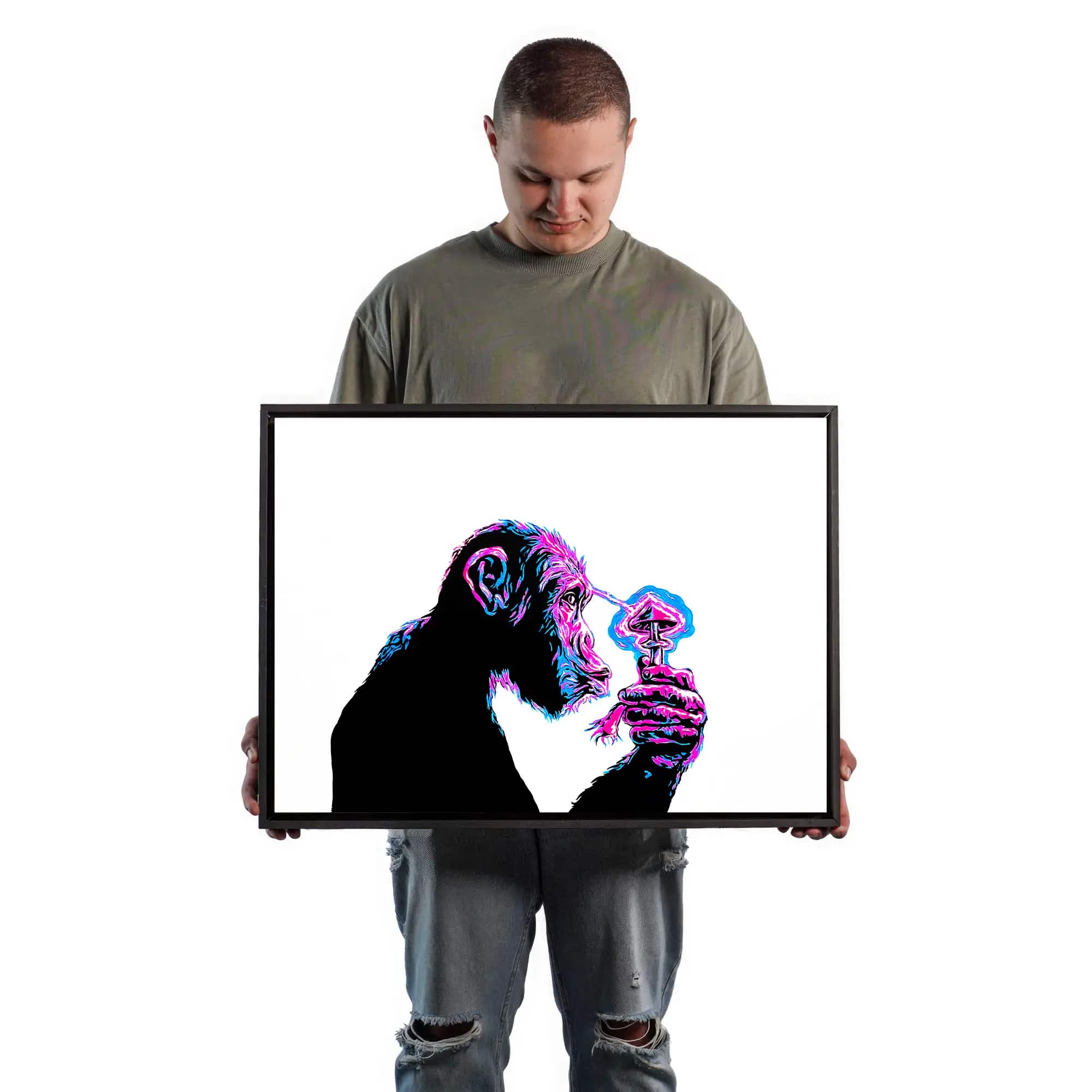 Artist holding portraits of Stoned Ape: on the left, a 50x70 centimeter stencil art. The picture is being used as a size reference, comparing it to the size of a real human body.
